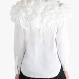 White shirt worn by a person, showing the shirt's fit