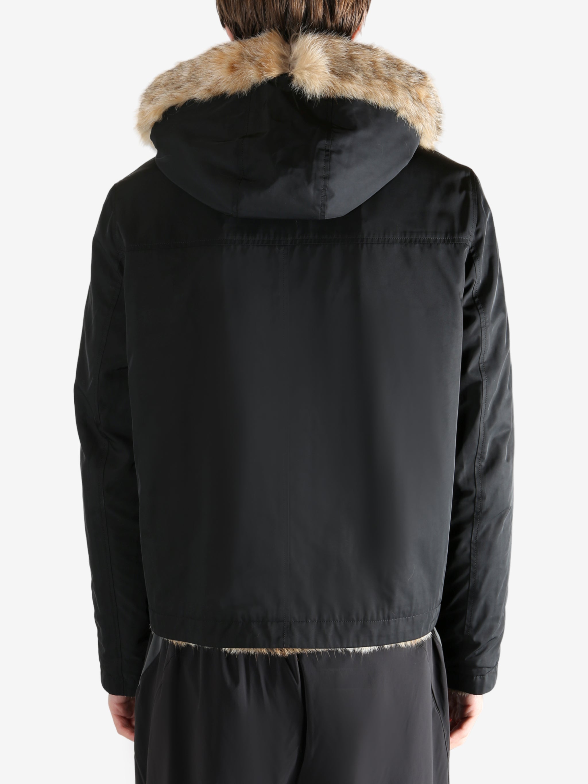 Black jacket worn by a person, showing the jacket fit