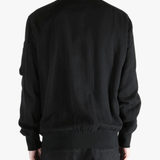 Black jackets-coats worn by a person, showing the cotton fit