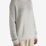 White top worn by a person, showing the top fit