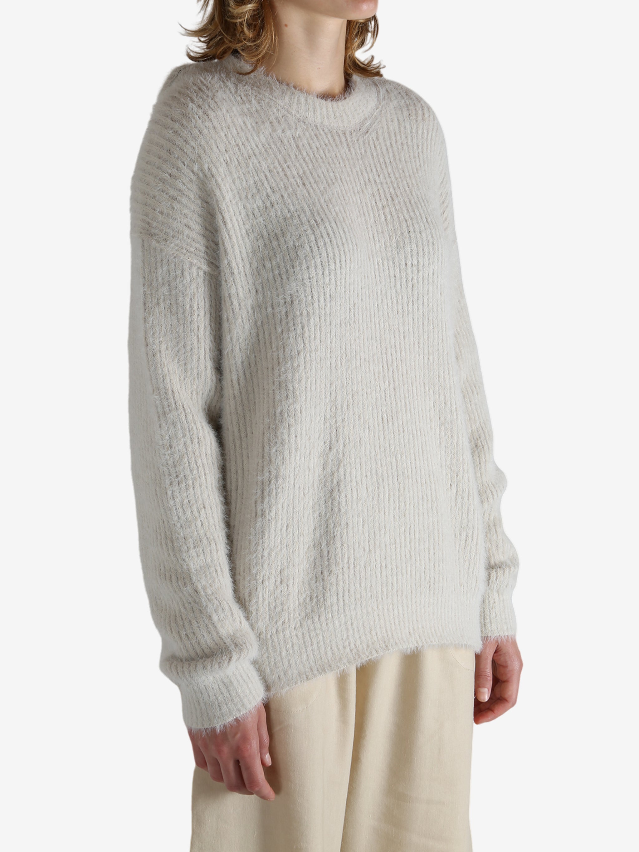 White top worn by a person, showing the top fit