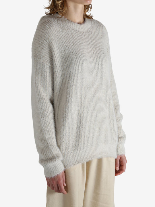 White top worn by a person, showing the top fit