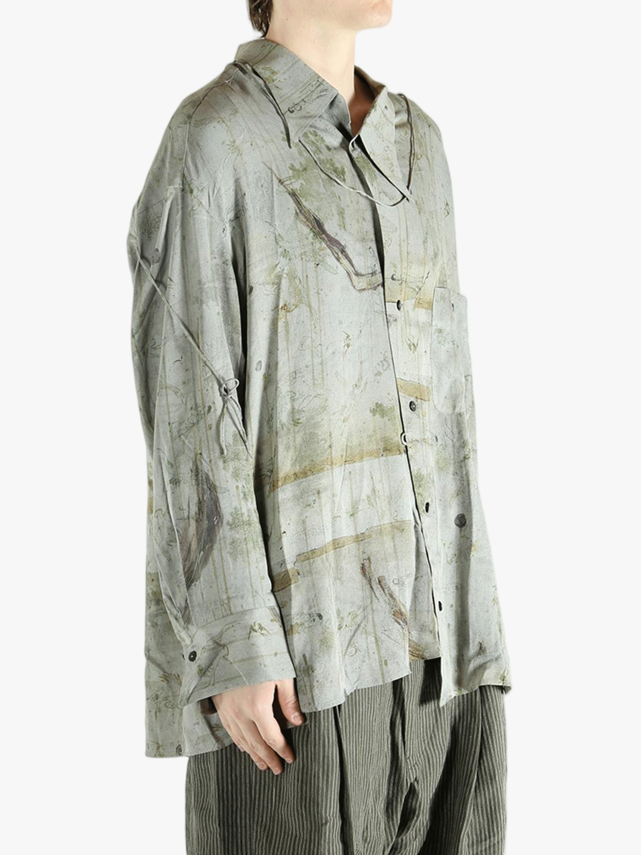 Green shirt worn by a person, showing the shirt's fit