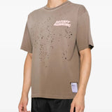 Tan t-shirt worn by a person, showing the t-shirt fit