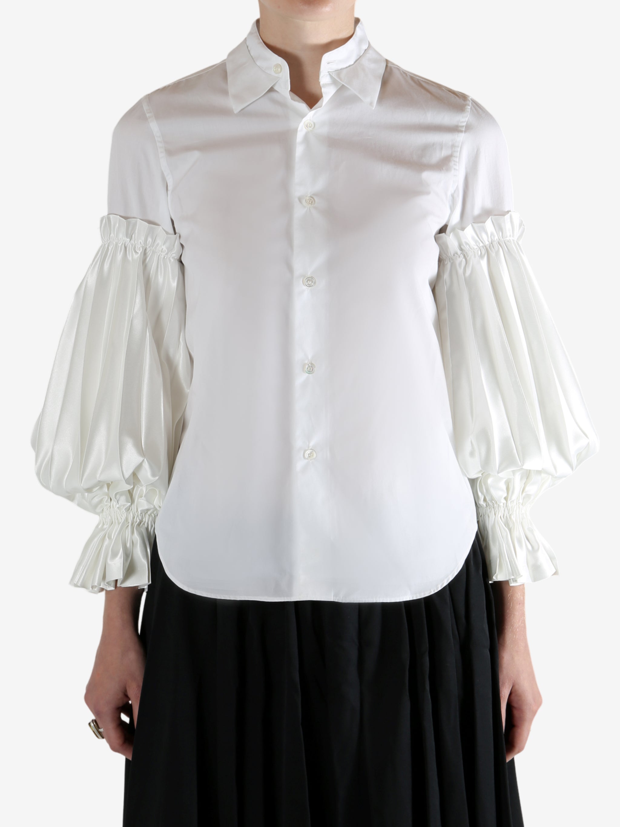 White shirt worn by a person, showing the shirt's fit