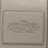 Close up of grey bag, showing brand logo