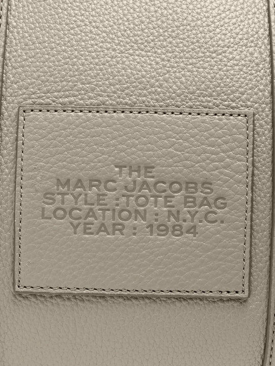 Close up of grey bag, showing brand logo