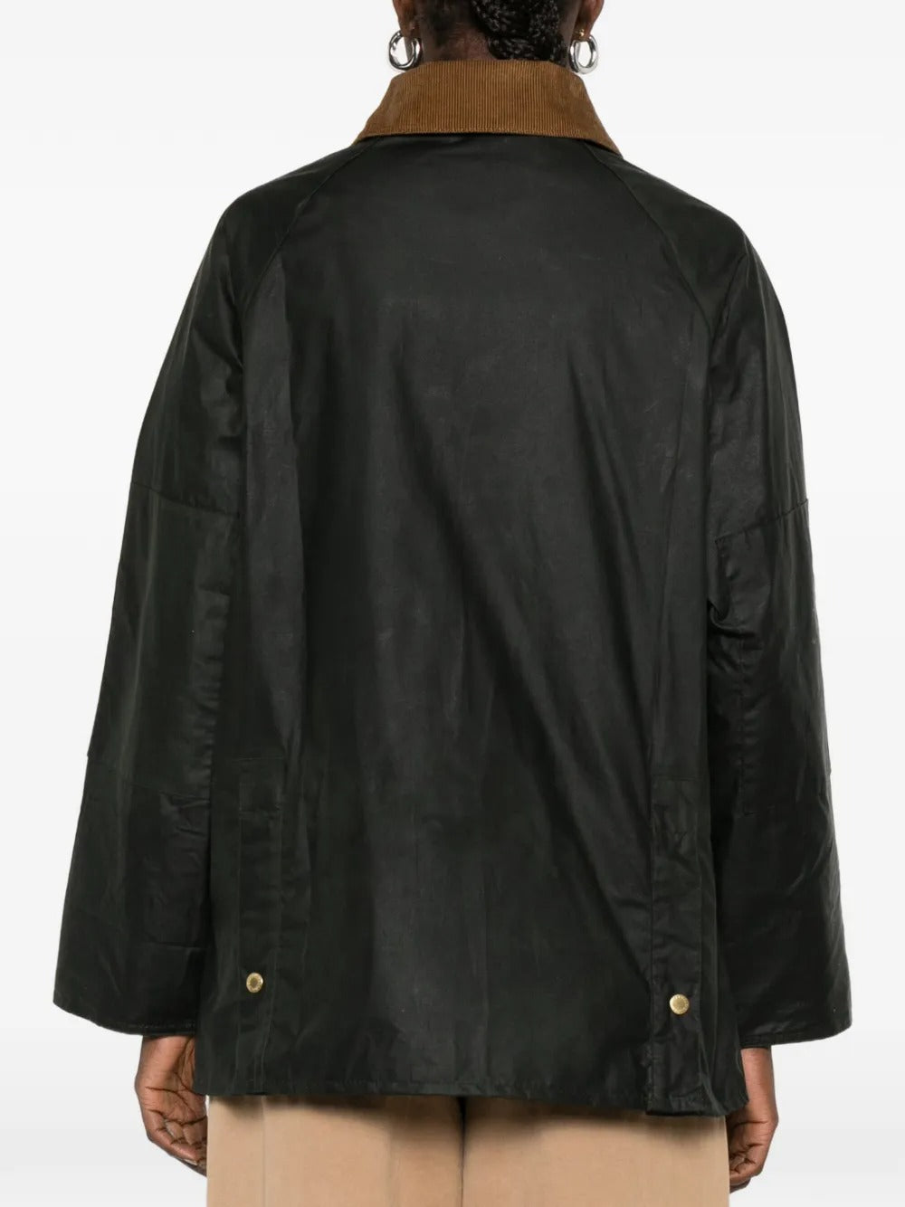 Green jacket worn by a person, showing the jacket's fit