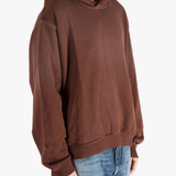 Brown sweats-hoodies worn by a person, showing the cotton fit