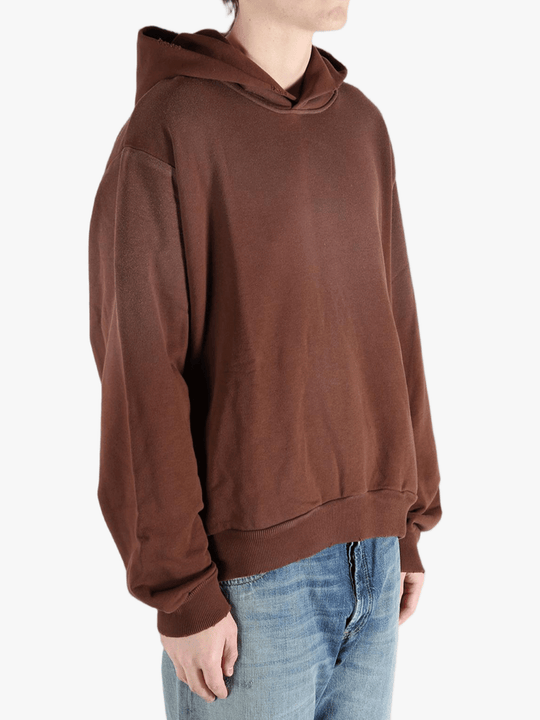 Brown sweats-hoodies worn by a person, showing the cotton fit