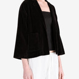 Black jacket worn by a person, showing the jacket fit