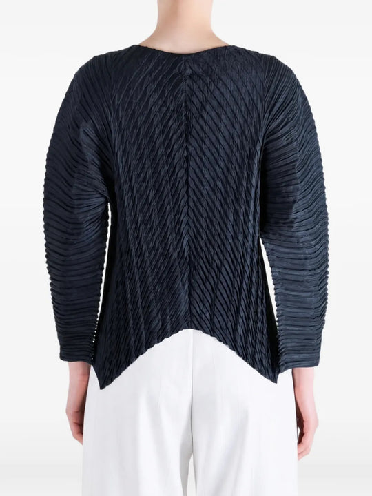 Navy knitwear worn by a person, showing the knitwear fit