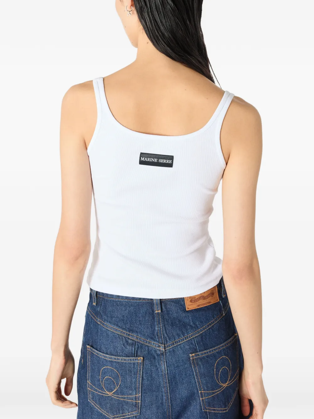 White top worn by a person, showing the top's fit