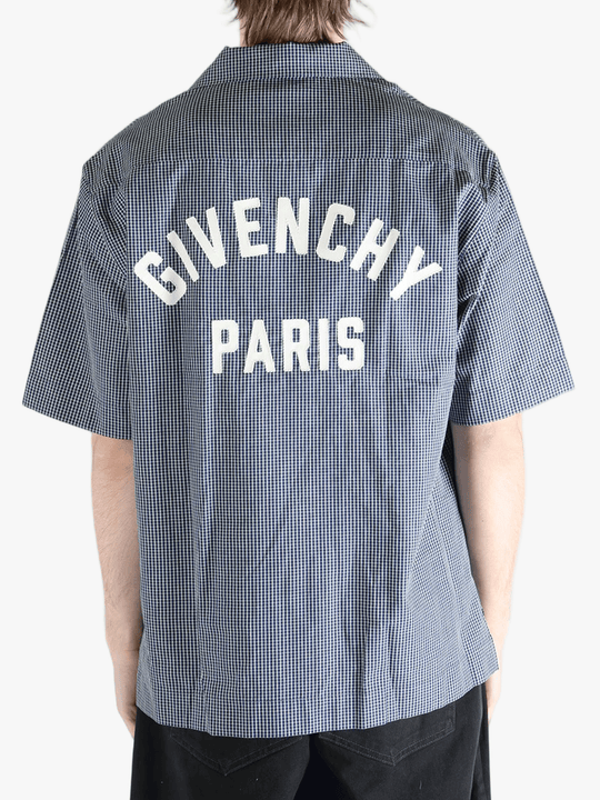 Blue checkered shirt worn by a person, showing the shirt's fit