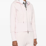 Pink hoodie worn by a person, showing the hoodie's fit