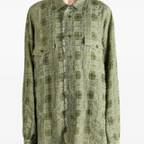 Green top worn by a person, showing the top fit