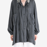 Grey shirt worn by a person, showing the shirt fit