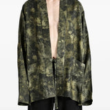 Green jacket worn by a person, showing the jacket fit