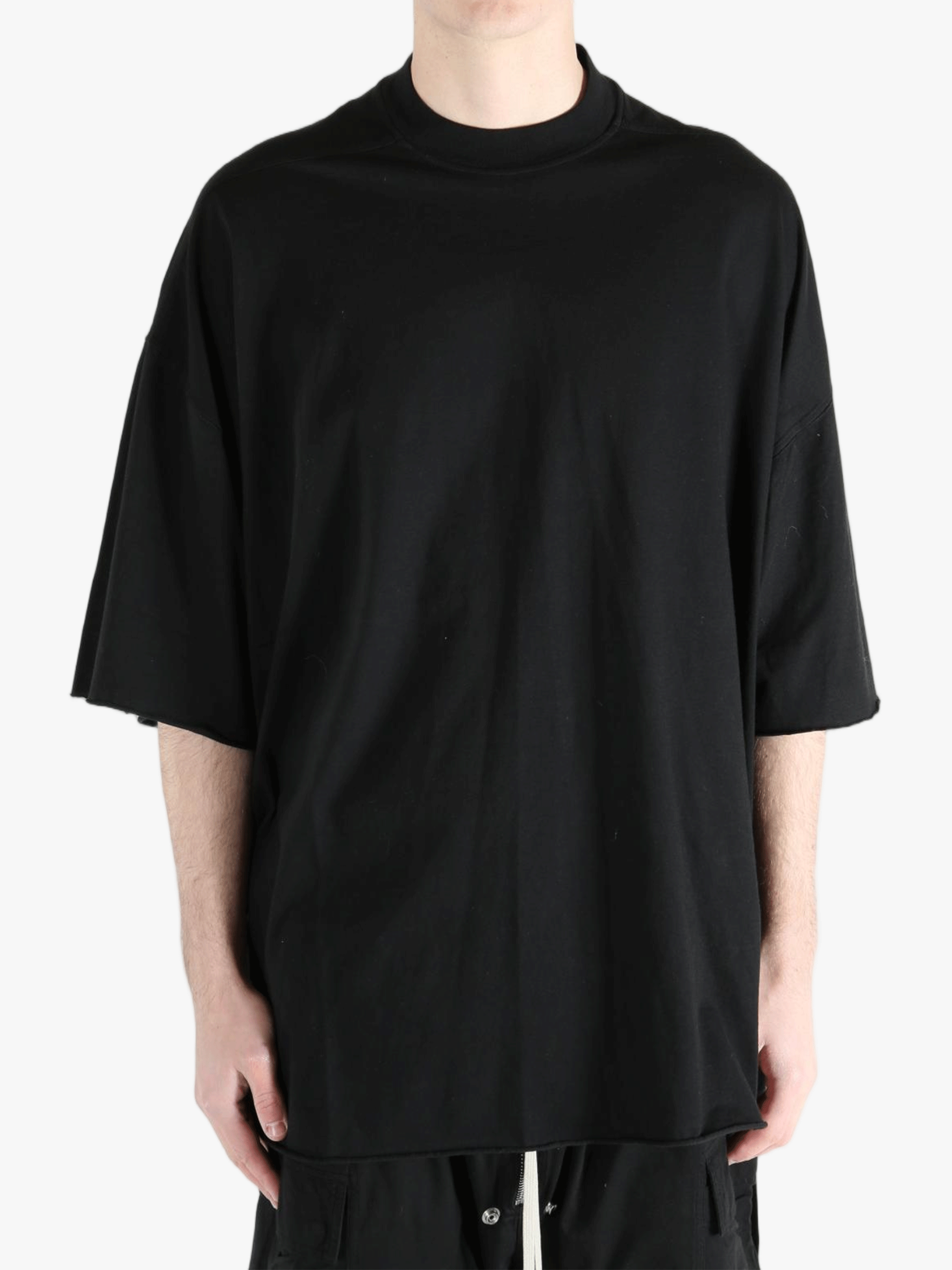 Black t-shirts worn by a person, showing the t-shirts fit