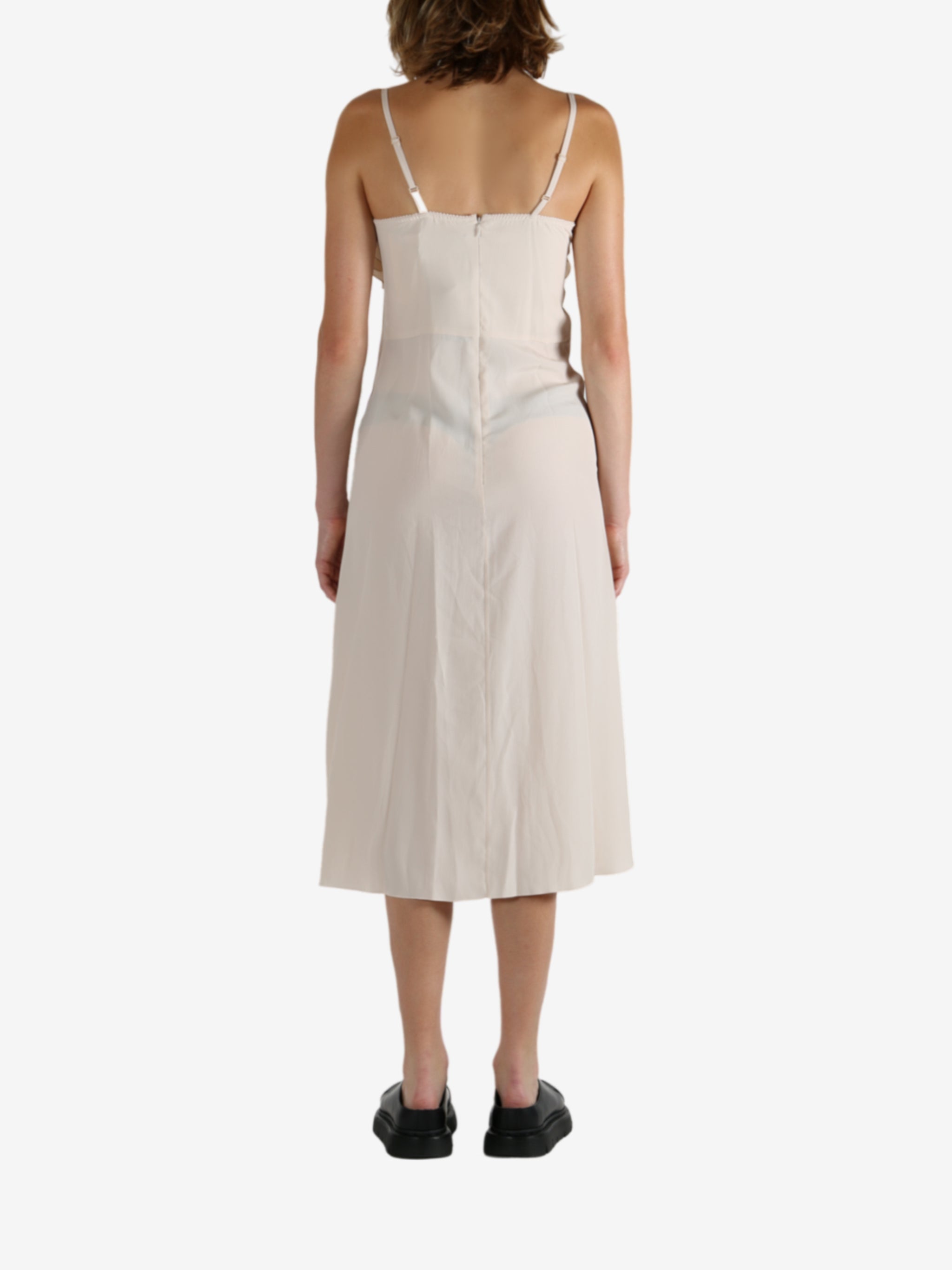 White dress worn by a person, showing the dress's fit