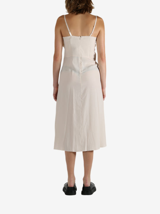 White dress worn by a person, showing the dress's fit