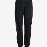 Black pants worn by a person, showing the pants fit