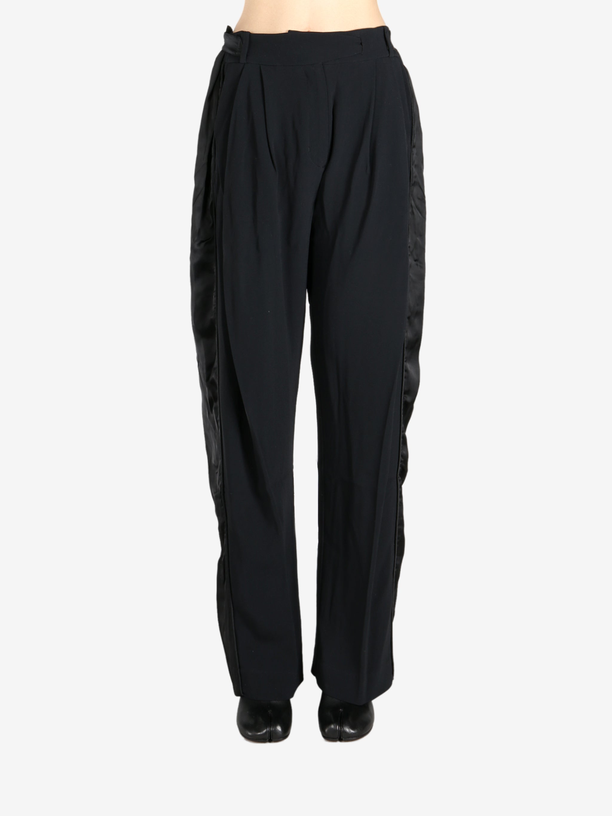 Black pants worn by a person, showing the pants fit