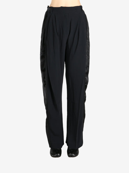 Black pants worn by a person, showing the pants fit