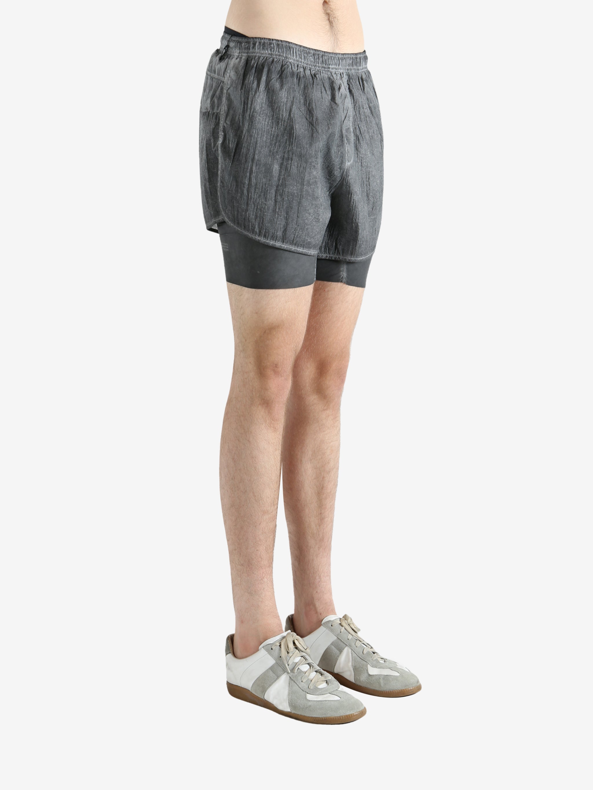 Grey shorts worn by a person, showing the shorts fit