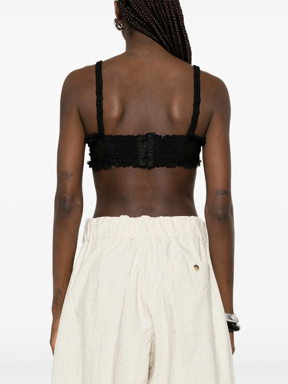 Black top worn by a person, showing the top fit