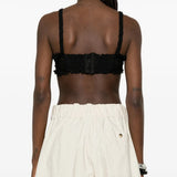 Black top worn by a person, showing the top fit