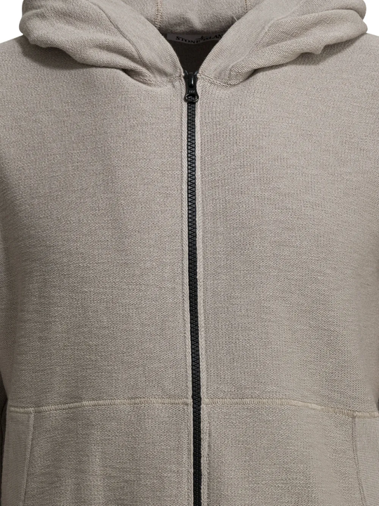 Close-up of a gray hoodie with a zipper