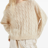 Tan knitwears worn by a person, showing the knitwears fit