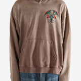 Brown hoodie worn by a person, showing the hoodie's fit