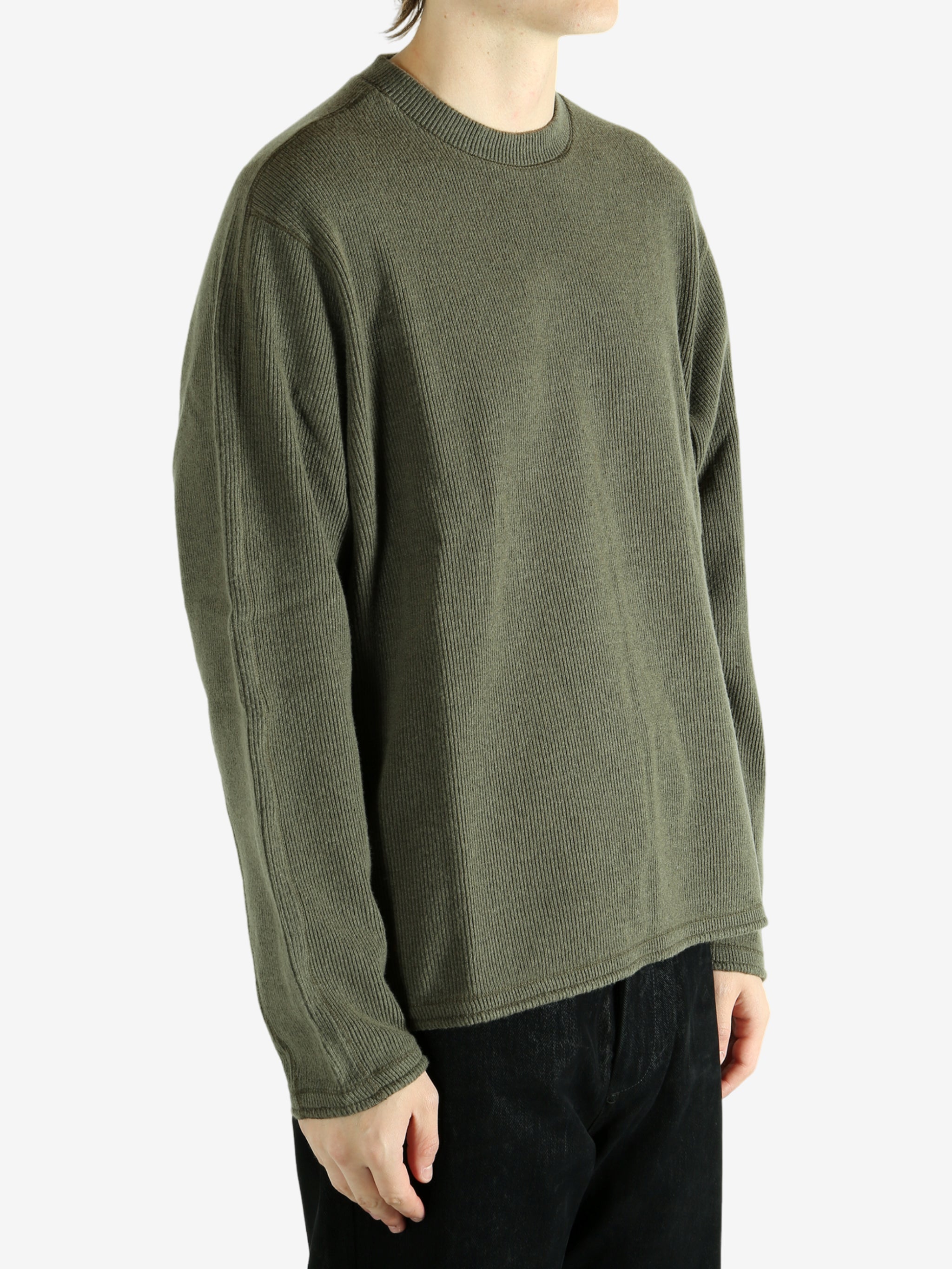 Green shirt worn by a person, showing the shirt's fit