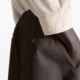 Close up of brown pant, showing texture of the cotton fabric