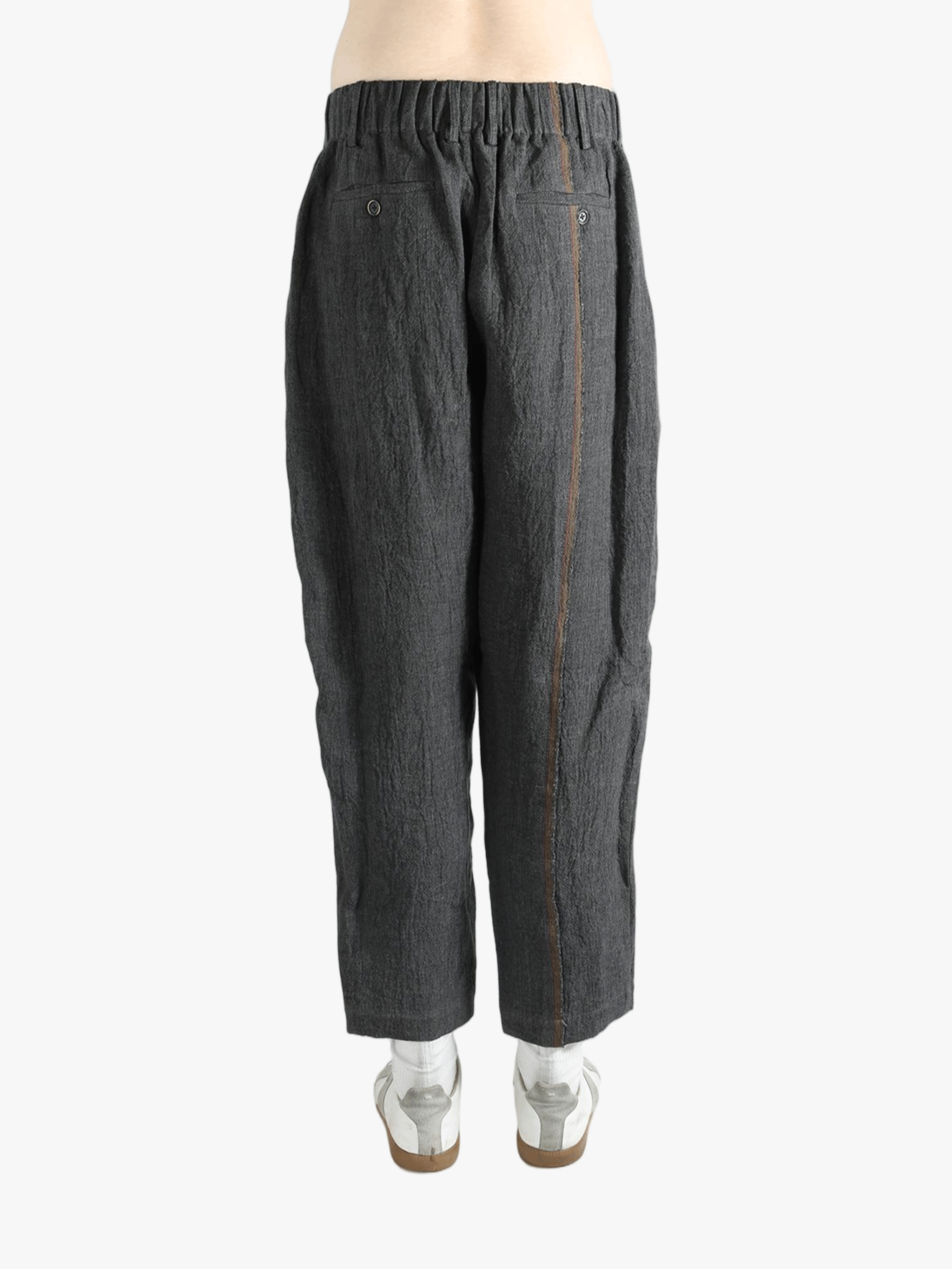 Grey pants worn by a person, showing the pants' fit