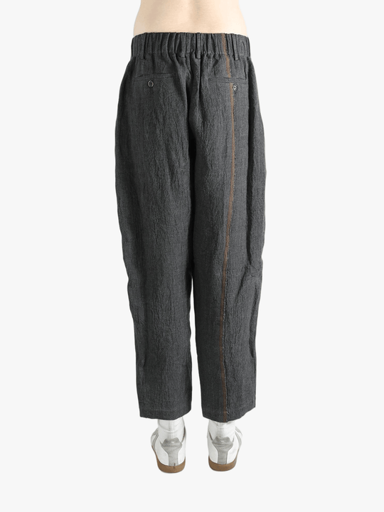 Grey pants worn by a person, showing the pants' fit