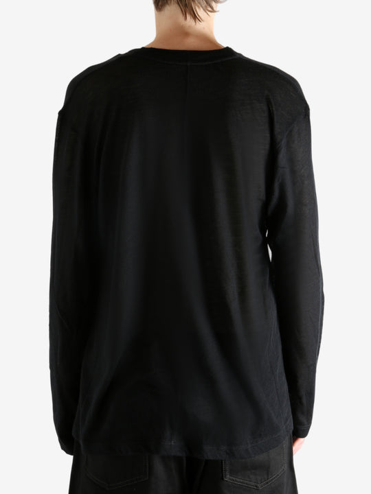 Black top worn by person, showing the top's fit