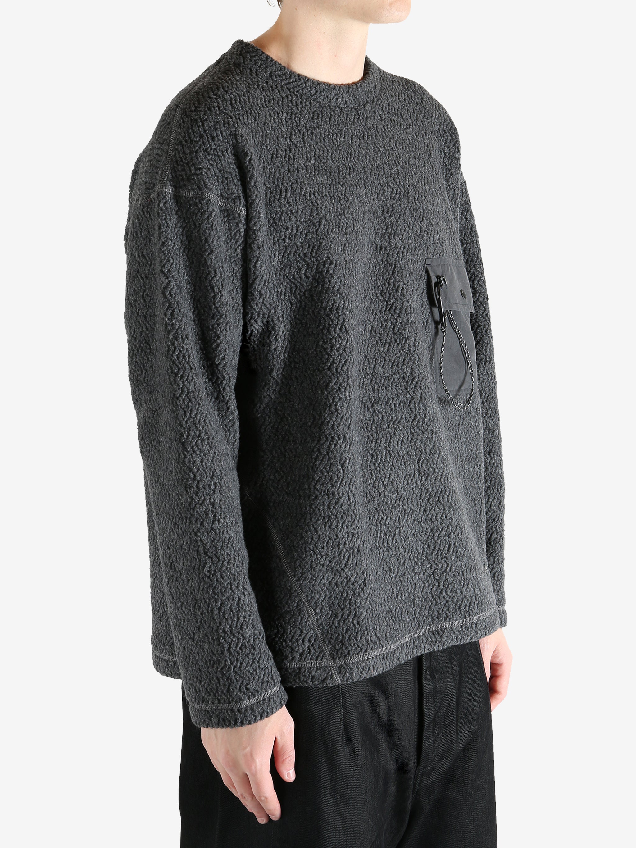 Grey jackets worn by a person, showing the jackets fit