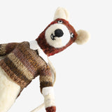 Close up of tan doll, showing texture of the wool and cotton and linen fabric