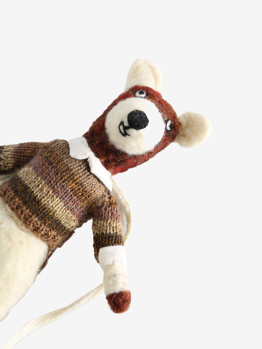 Close up of tan doll, showing texture of the wool and cotton and linen fabric