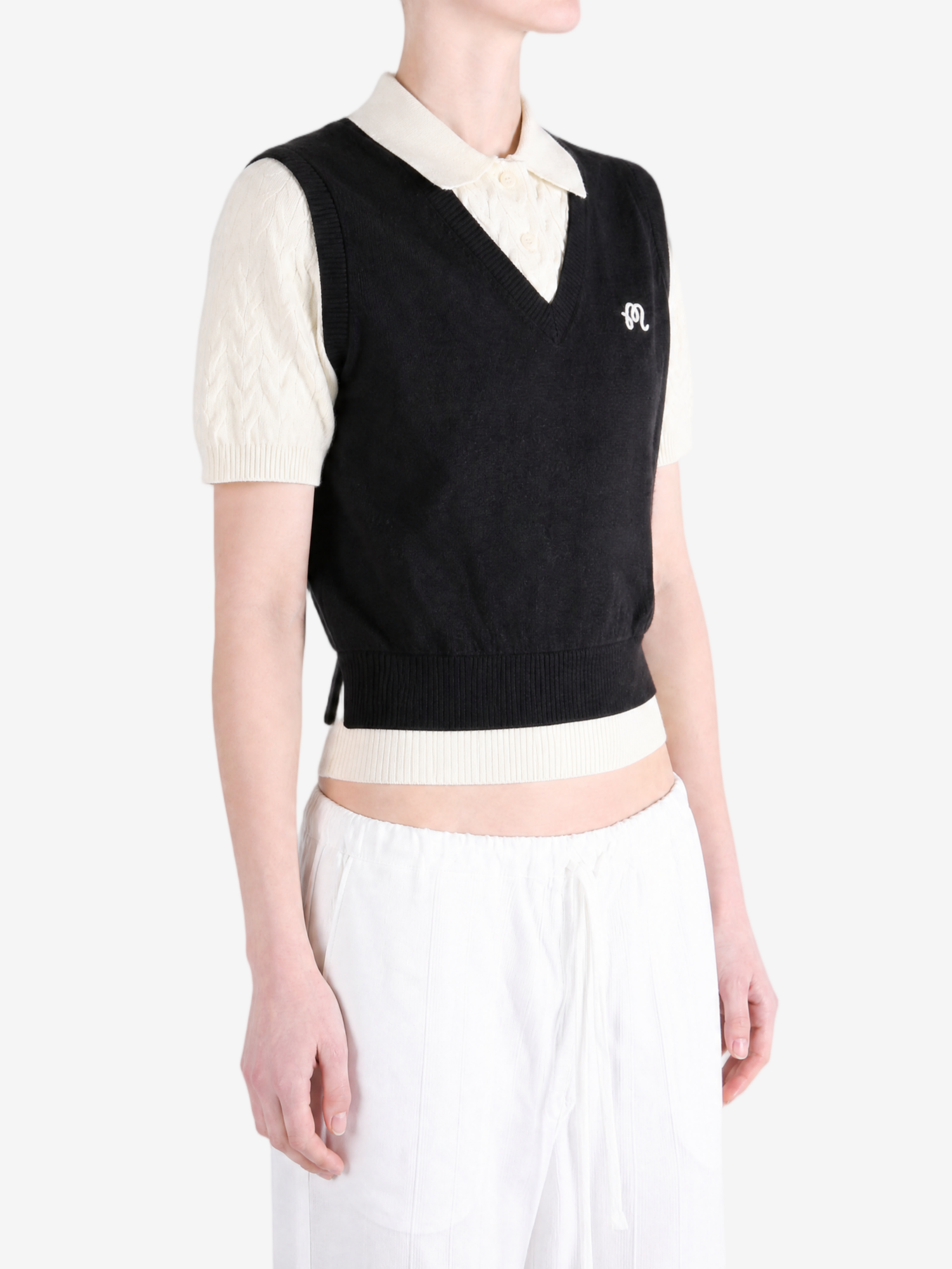 Black shirt worn by a person, showing the shirt fit