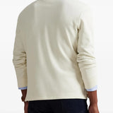 Tan knitwear worn by a person, showing the knitwear fit