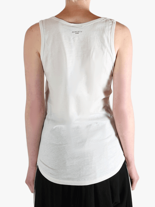 White top worn by a person, showing the top's fit