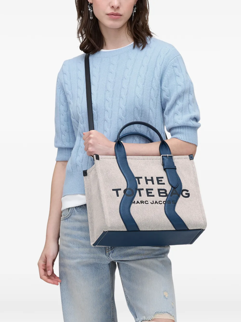 Navy bag,worn by a person, showing the bag fit