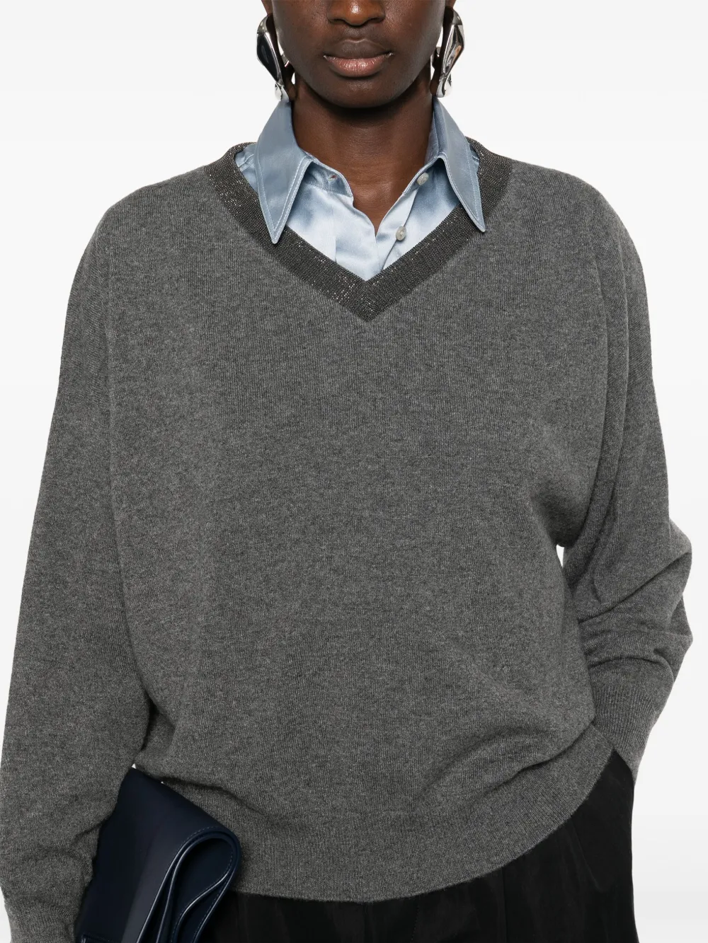 Grey knitwears worn by a person, showing the knitwears fit