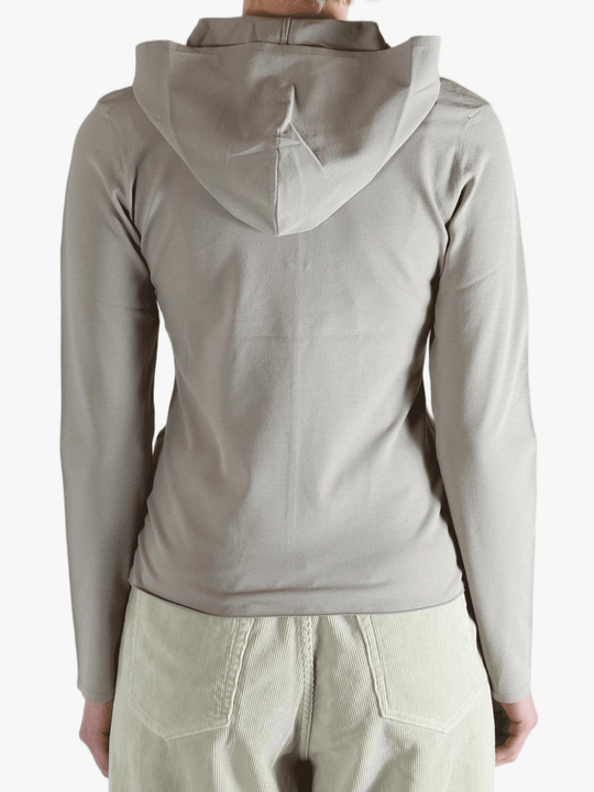 Grey knitwear worn by a person, showing the knitwear fit
