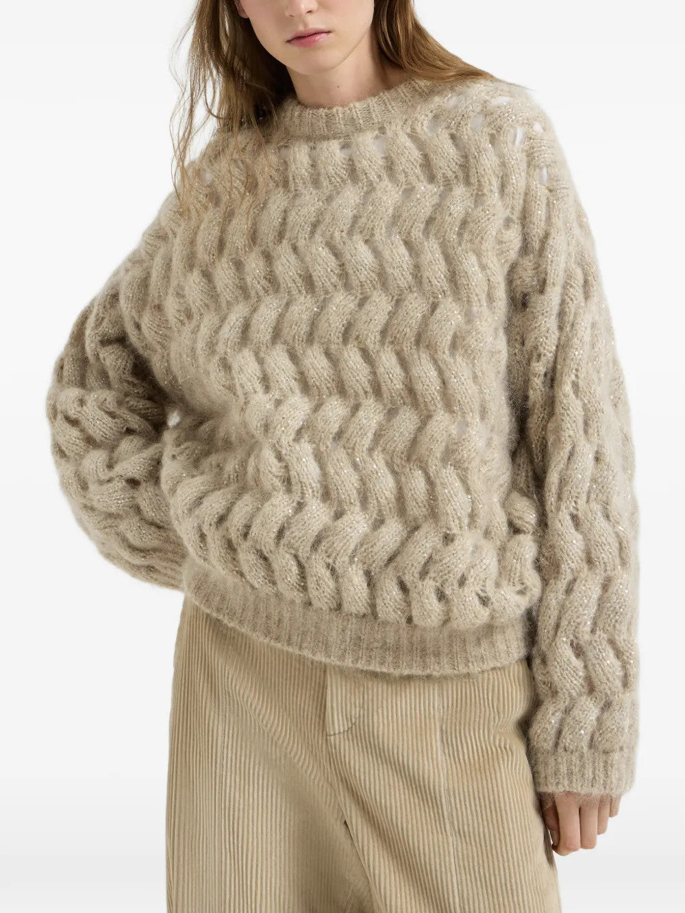 Tan knitwear worn by a person, showing the knitwear fit
