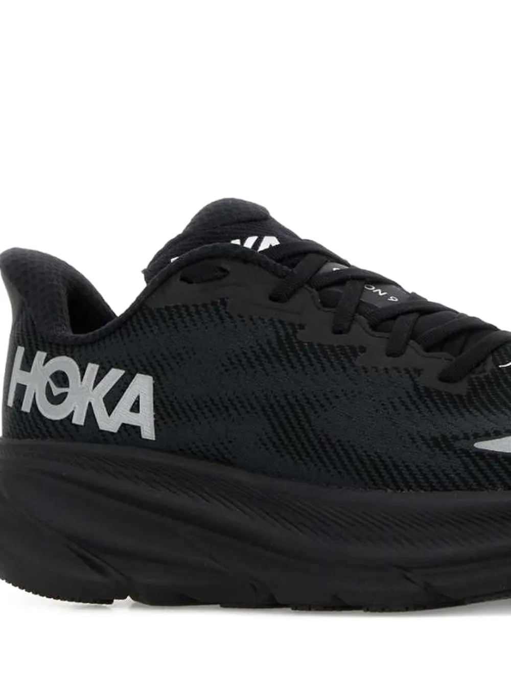 Close up of the black sneakers, showing texture of the mesh